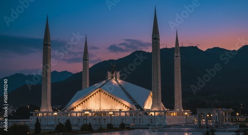 Faisal Mosque Islamabad with dramatic mountain backdrop and evening lights