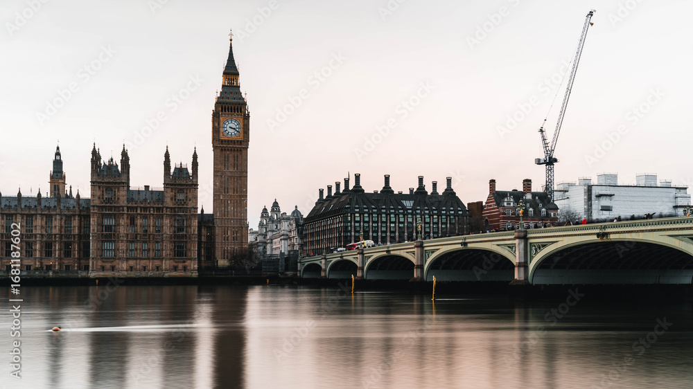 Fototapeta premium Palace of Westminster and Big Ben at night with smooth river reflections, long exposure on the Thames