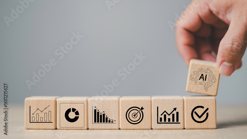 AI assistant to business target and automation strategy concept with wooden blocks showing charts, analytics, goals, and AI brain icon, smart technology and digital transformation solutions.