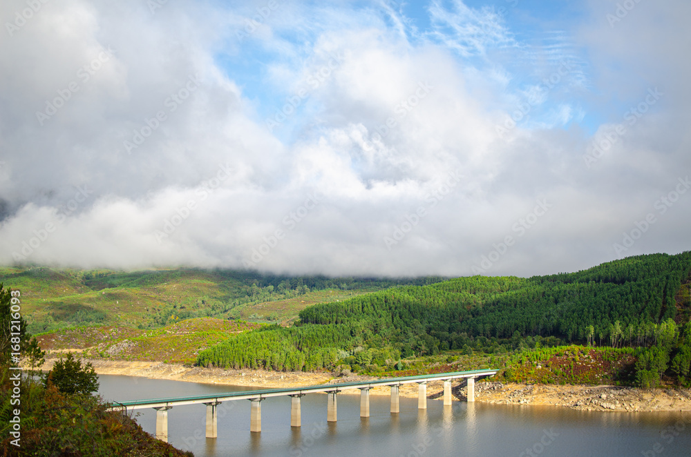 Fototapeta premium A modern bridge crossing a beautiful lake in the mountains The Power of Human Engineering