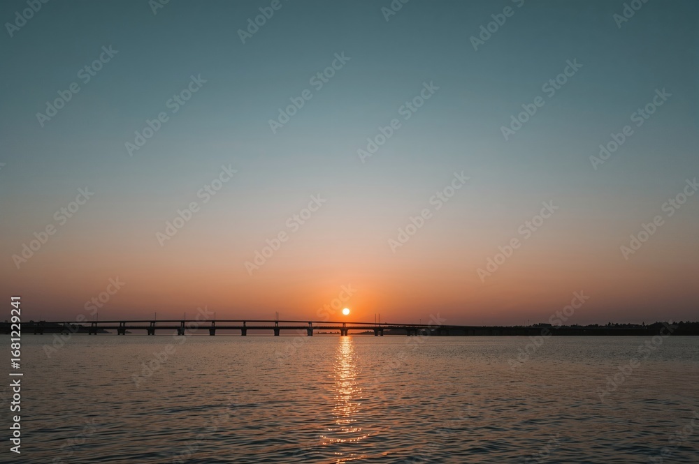 Fototapeta premium Evening view with a bridge over calm waters