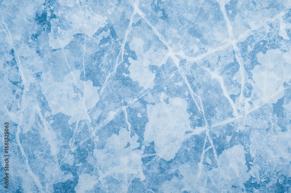 Fototapeta premium Top-down view of a scratched icy surface with skate marks on a blue ice rink floor