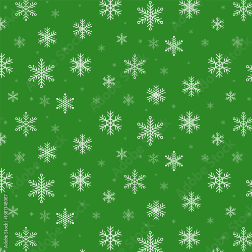 Seamless pattern with white snowflakes isolated on green background.Christmas snowflake repeat pattern.Winter wallpaper background.