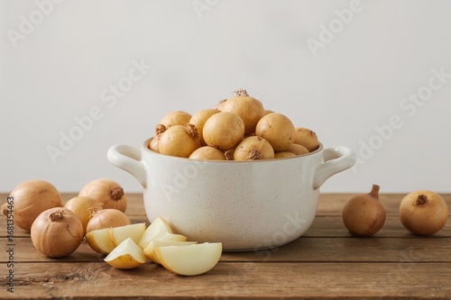 Raw peeled potatoes and oni...