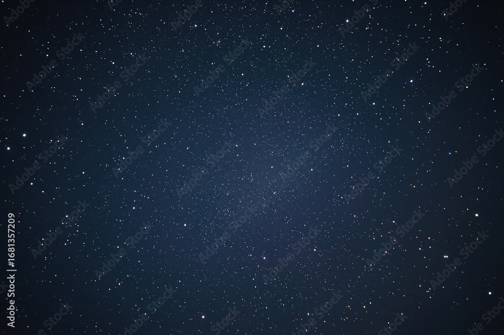 Obraz premium Nighttime cityscape beneath a star-filled sky