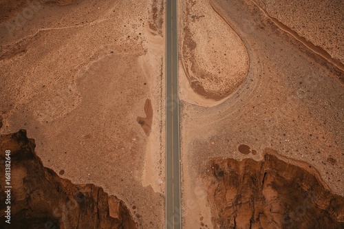 Aerial abstract shot capturing the vast desert terrain from above, blending naturalism with figurative elements