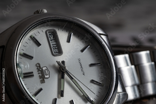 Close up of wrist watch with broken and scratched glass, automatic movement