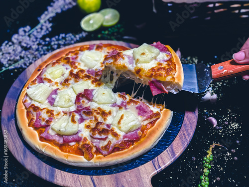 Hawaiian pizza topped with pineapple, bacon, and melted cheese, delicious and savory.