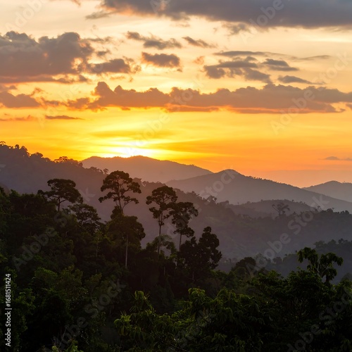 Wallpaper Mural A vibrant sunset paints the distant mountain ranges, silhouetting dense tropical forests in a breathtaking display of natural beauty. Torontodigital.ca