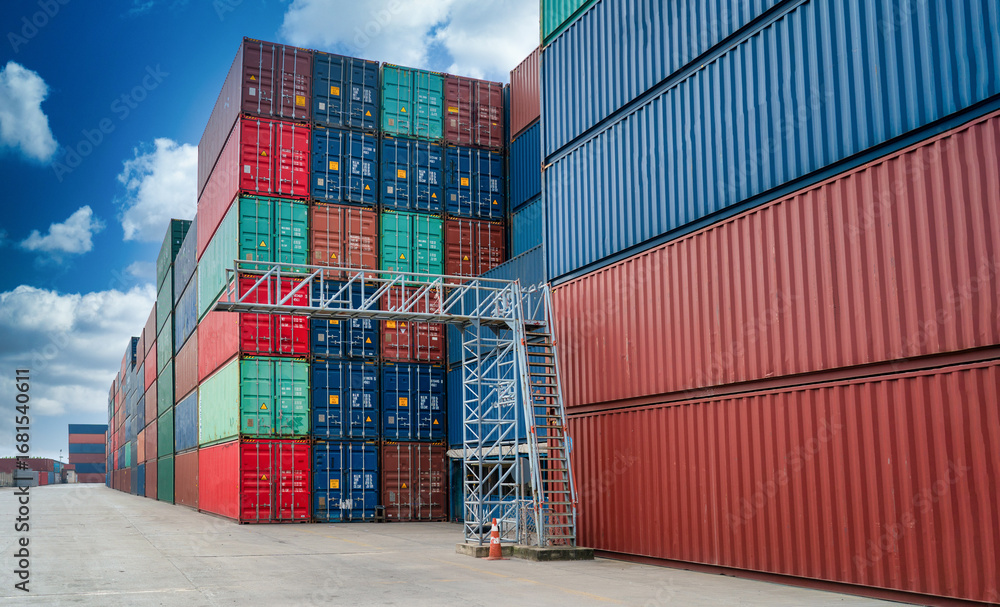 Fototapeta premium Cargo Container Stack Pile Background in Yard cargo container background at daytime. Logistics global import or export shipping industrial concept.