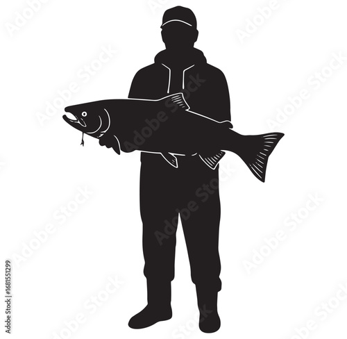 Silhouette of a fisherman holding a large salmon fish after successful fishing trip