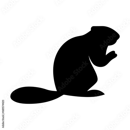 Beaver standing on hind legs in silhouette