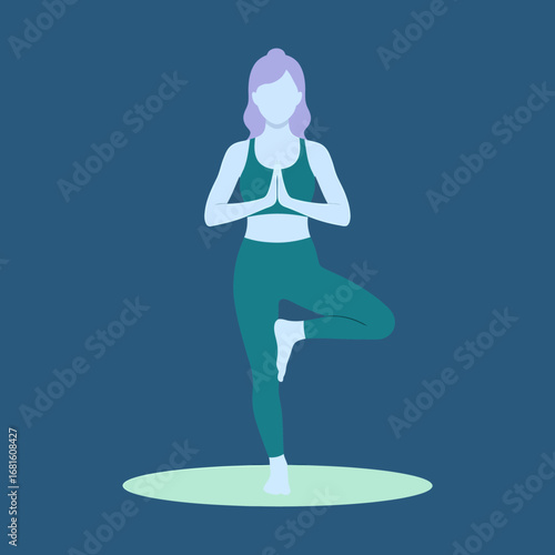  Woman in Yoga Tree Pose (Vrksasana) with Hands in Namaste.