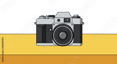 Analog camera Grey and black camera on layered yellow table with white backdrop