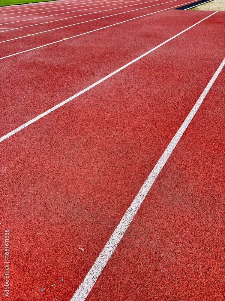 Fototapeta premium Red track lanes leading to success, ideal for sports, fitness, competition, and achieving goals
