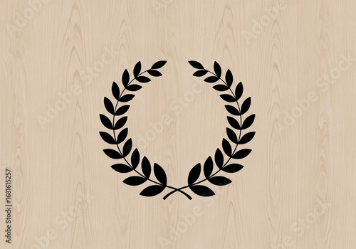 A simple, black laurel wreath is centered on a light beige wooden background