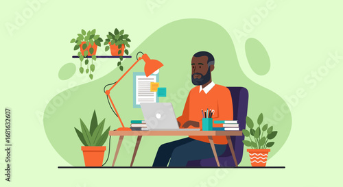 Focused Black man working remotely on a laptop at a desk with plants. Represents productivity, home office, and modern work-life balance.