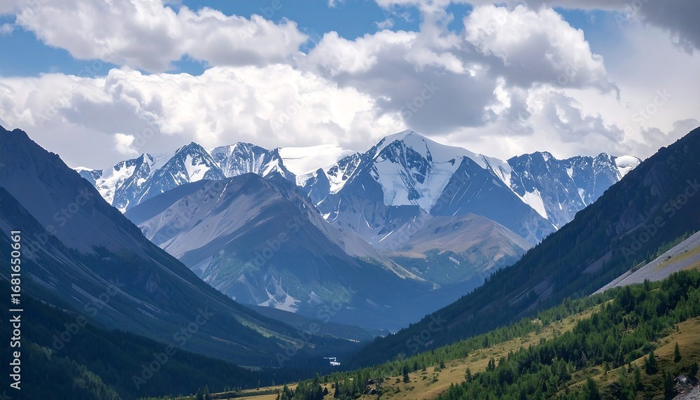 Fototapeta premium Majestic mountain range with snow-capped peaks under a cloudy sky.