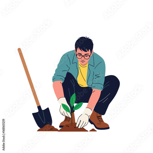 A man carefully planting a young sapling into fertile ground with a shovel nearby