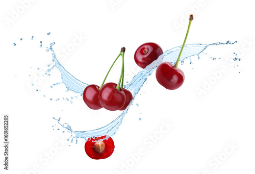 Fresh cherries and splashing water in air against white background
