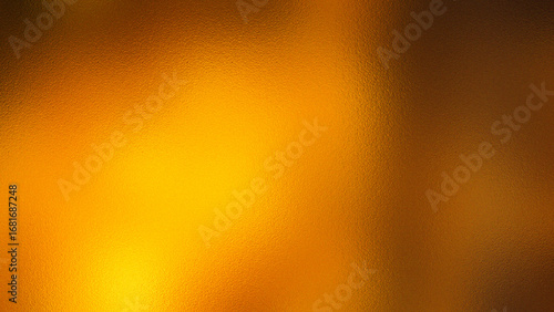 Abstract warm golden yellow and brown textured background with soft light and bokeh effects