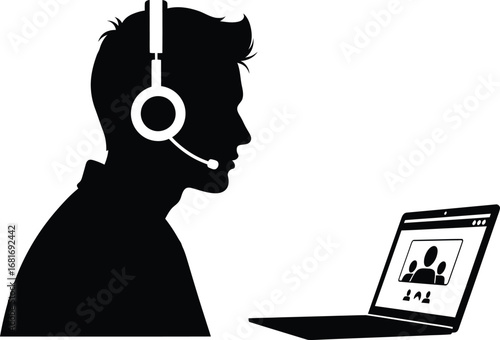 Silhouette of a man with headset having an online video call his laptop