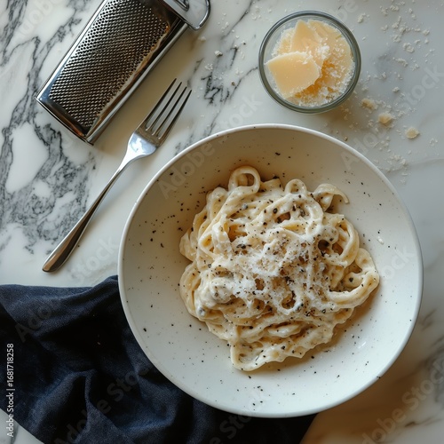 Creamy Pasta With Herbs and Cheese Served in a Bowl on a White Table.