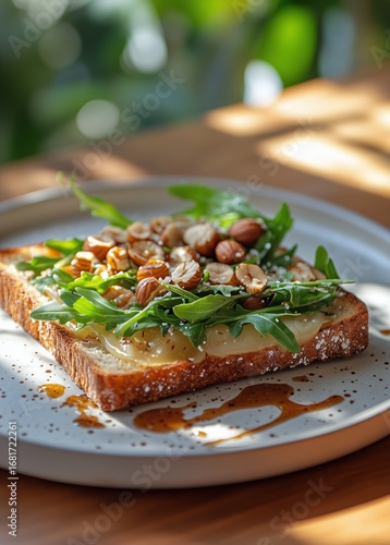 Delicious Open-Faced Sandwich Topped With Fresh Greens and Nuts Served on a W...
