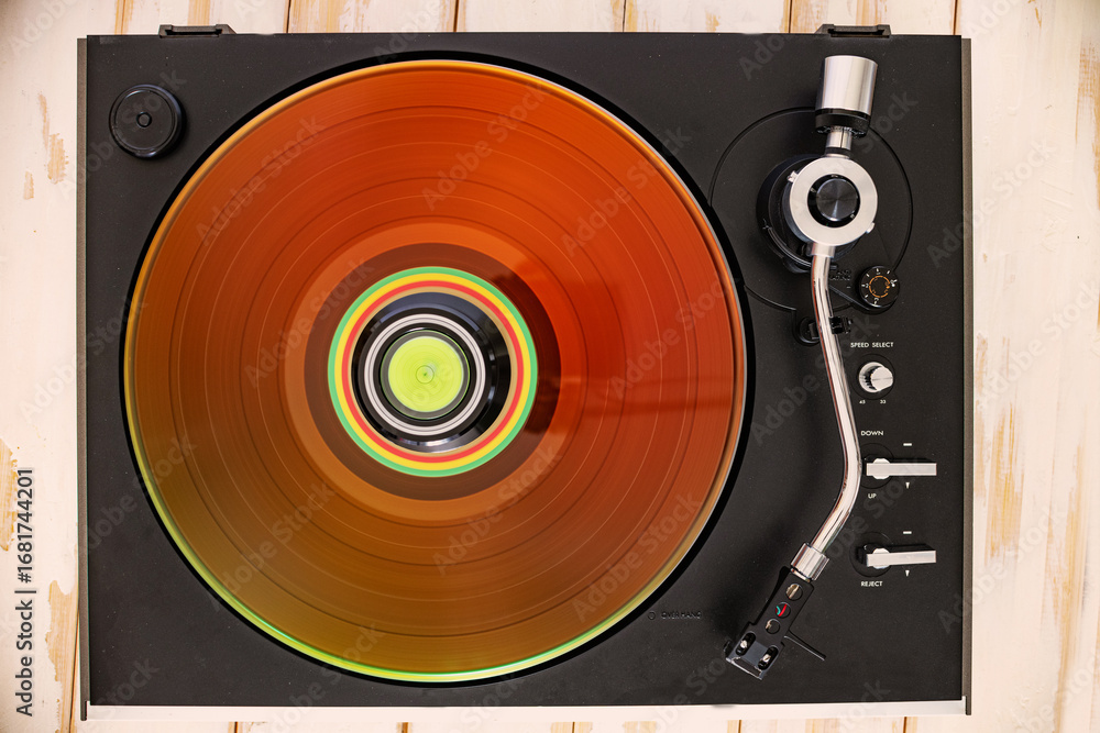 Obraz premium Spinning record, needle arm in natural light. Top view of hi-fi turntable,