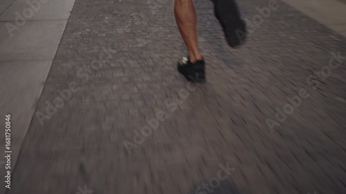 Rear view of man running on urban street in early morning light. Concept of freedom, energy, and strength, seeking inspiration for innovation, technology, and personal progress
