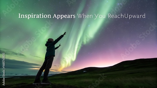 Person Reaching Upward Towards the Green Northern Lights.