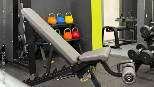 Dynamic fitness enclave flaunts vibrant kettlebells, sleek bench; celebrate Muscle Feast Day or invigorate for Fitness Fiesta