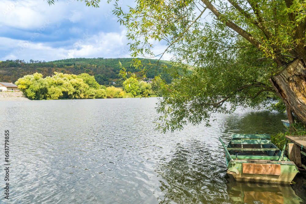 Φωτογραφία View of a wooden boat parked on a stormy summer day near the Berunka River,Czech