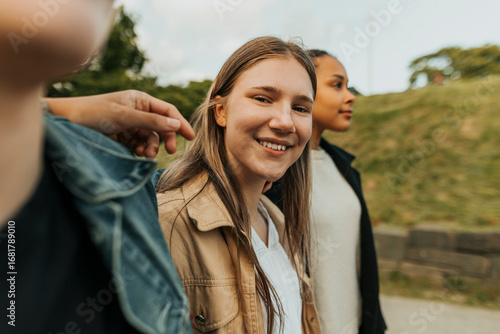 Portrait of smiling young woman hanging out with friends