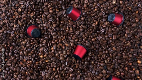 Espresso coffee capsules in red against a background of roasted coffee beans. Capsules for coffee machines. Conceptual image.