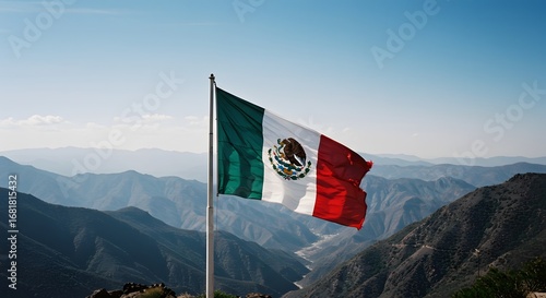 A vibrant Mexican flag waving against a backdrop of majestic mountains and a clear blue sky