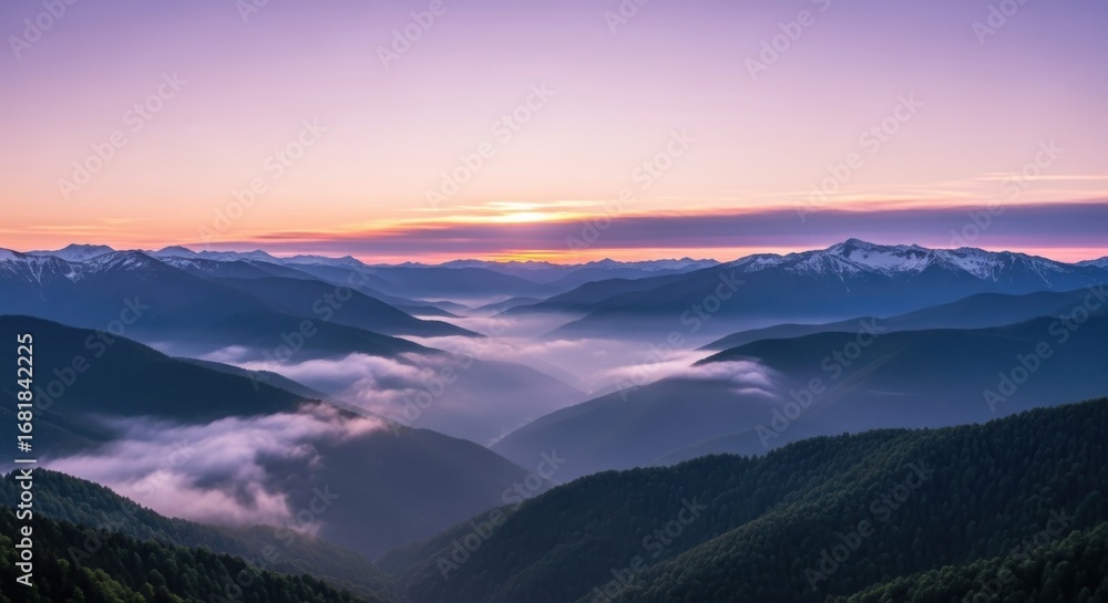 Obraz premium Majestic Mountain Range at Sunset with Fog Filled Valleys and Soft Light Displaying Natural Beauty