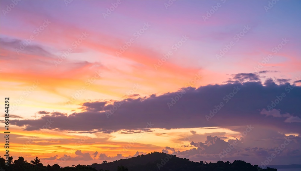 Fototapeta premium Striking tropical sunset casts vibrant hues across the horizon sky