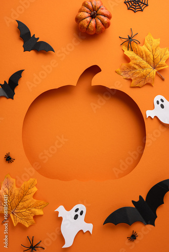Fotografie Festive vertical Halloween-themed orange background featuring a pumpkin cutout,
