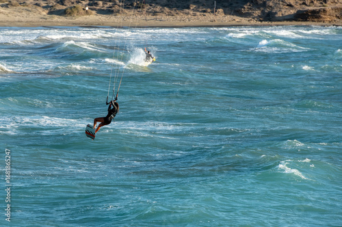 Kitesurfer enjoying the waves on a sunny day