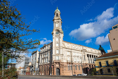 Historic Coffee Exchange Palace in Santos, São Paulo, Brazil. Iconic landmark with classical architecture and clock tower under blue sky.
