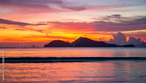 Vibrant sunset painting the serene ocean and distant islands