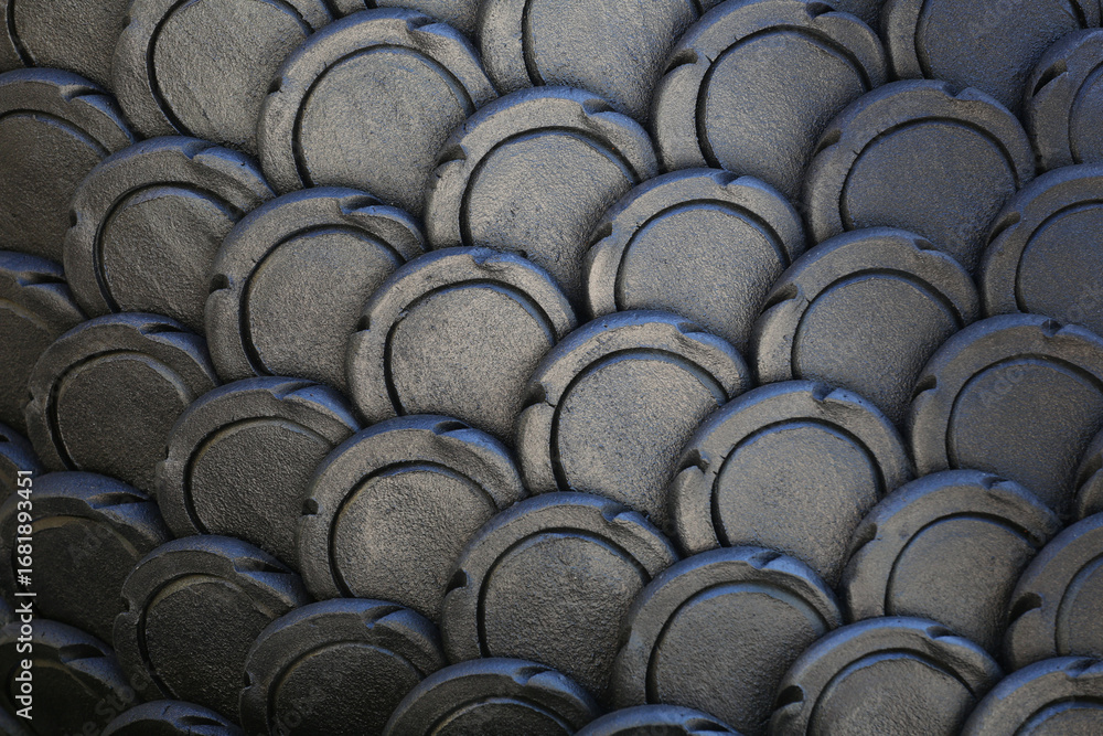 Obraz premium Gray patterns of stucco shaped like fish scales.
