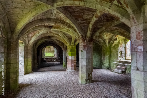 Stone vaulted ceiling and pillars in the medieval undercroft of Lanercost Priory