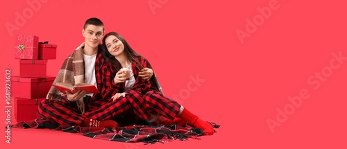 Young couple with book, cup...