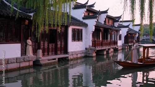 Female Standing Adjacent to Waterway in Garden City Observing Traditional Architectural Styles