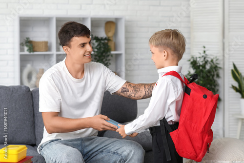 Father giving books to his ...
