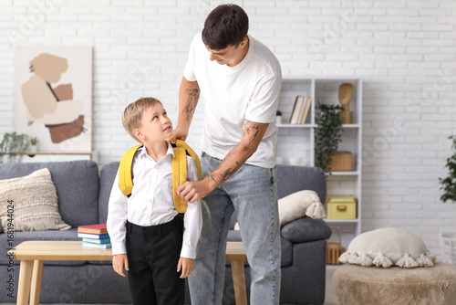 Father adjusting his little...