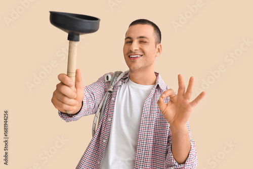 Male plumber with plunger s...