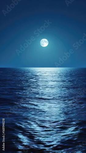 Glowing full moon over still ocean waters at night.